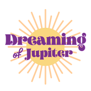 Bold purple text reads Dreaming of Jupiter with a large gold sun behind the text.